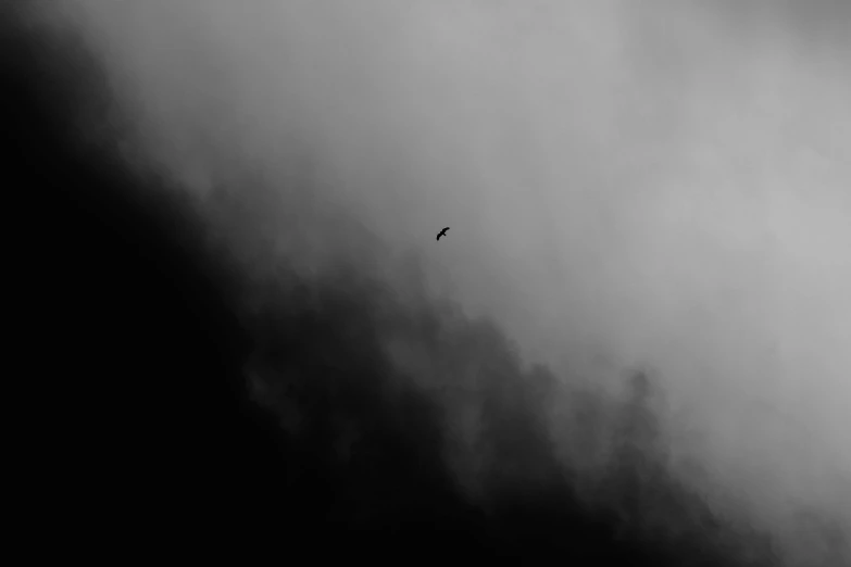 a plane flying through a dark cloudy sky