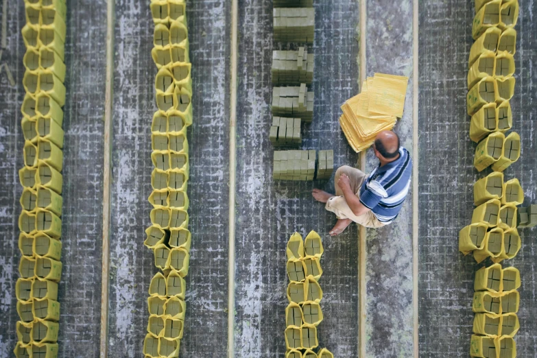 a woman sits in a yellow basket on top of the track