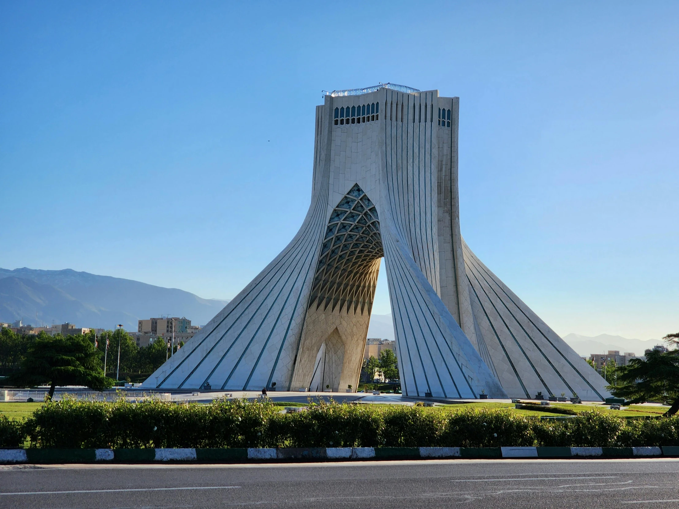 a large structure with a very long tail is next to the road