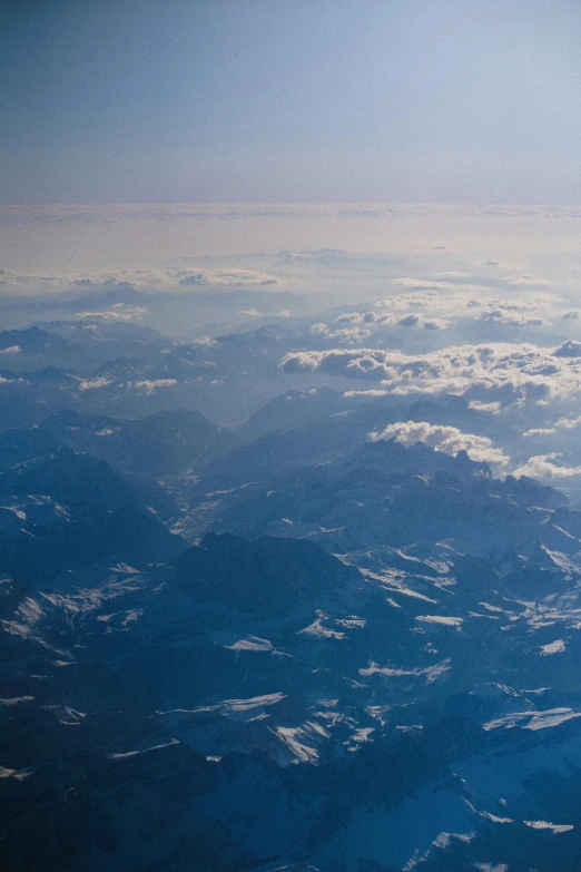 a view of the sky over some land from an airplane