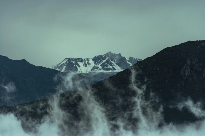 smoke billowing from the mountains on the horizon