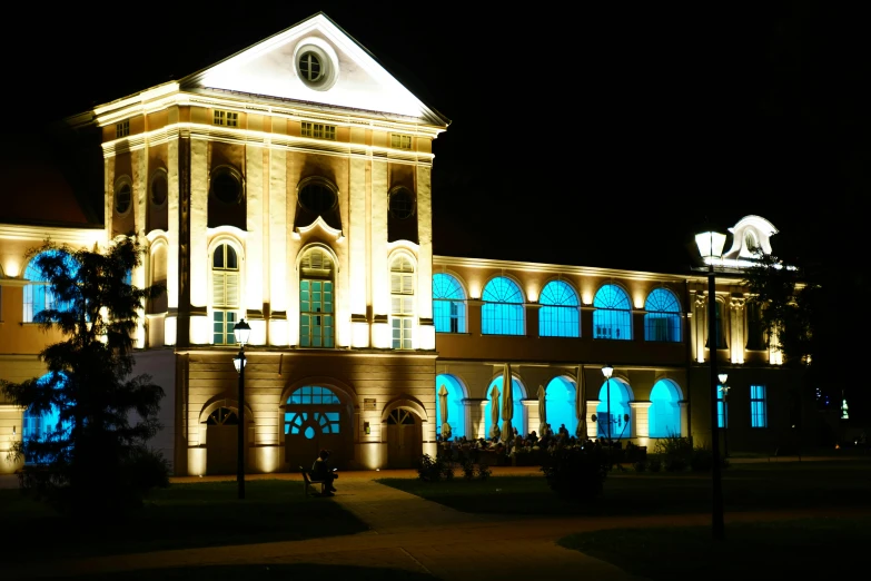 a big building with light up windows and lit up lights