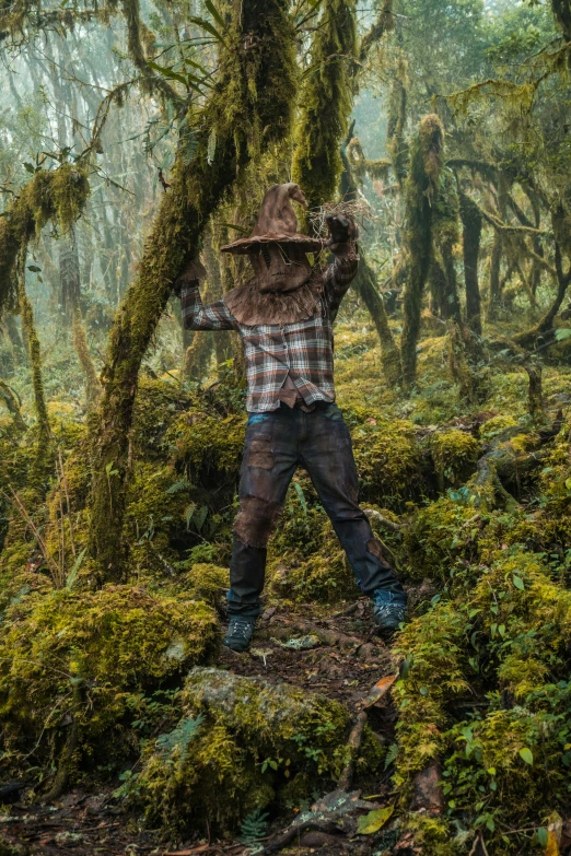 person in the woods wearing a large hat