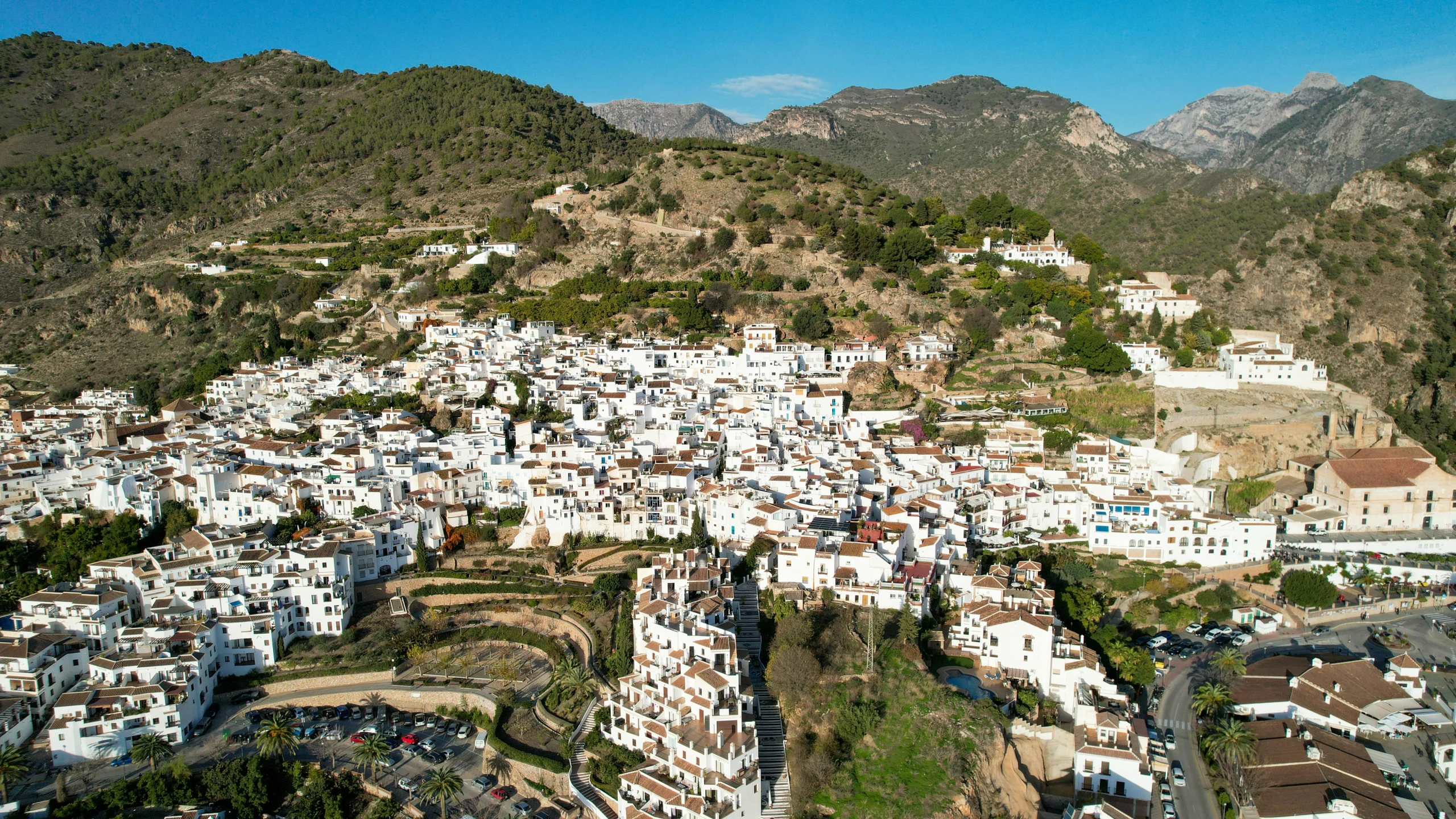 an aerial s of a city by the mountain