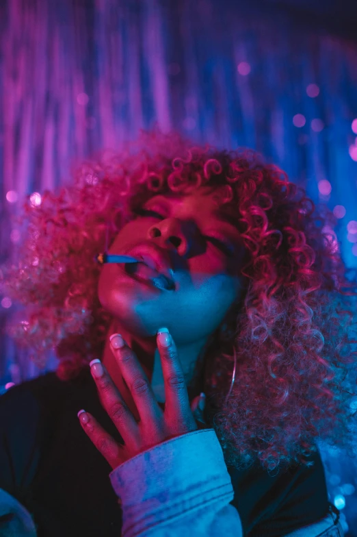 a girl with curly hair and earrings posing for the camera