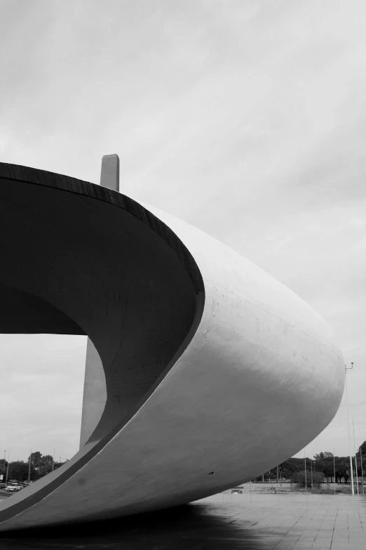 an unusual shaped building in front of a park