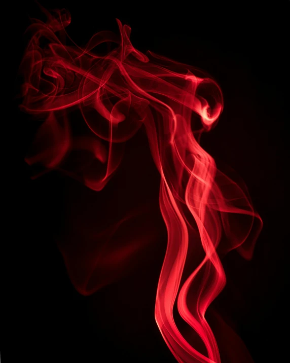 a bright red smoke with white streaks on a dark background