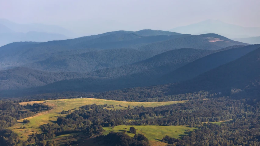 an area with hills and valleys covered in grass