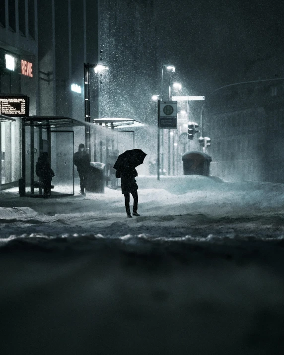 person in the dark with umbrella on a rainy night