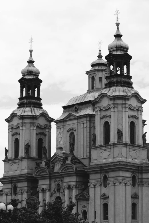 an old white church with two towers and two clocks