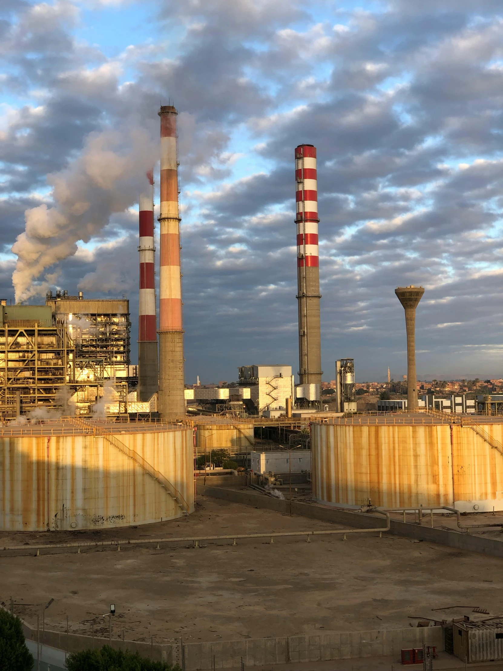 a factory has tall buildings with towers on the top