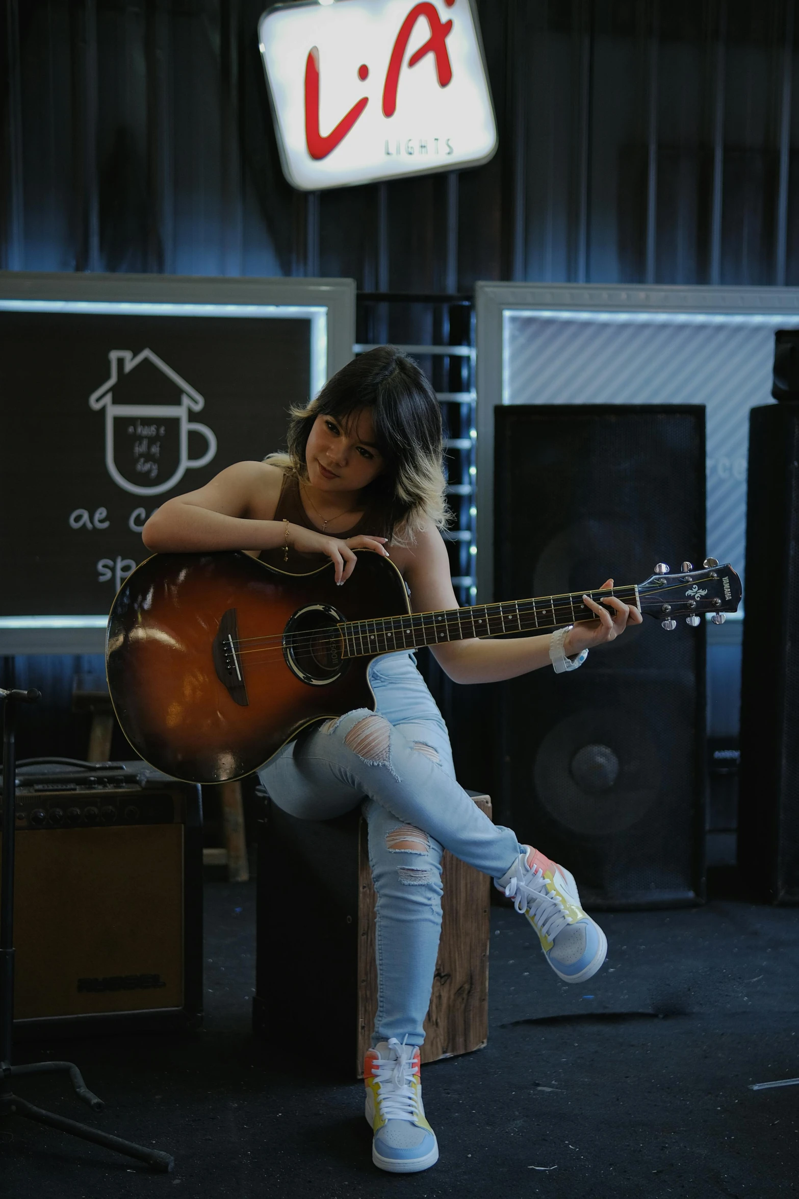 a girl with leggings playing an acoustic guitar