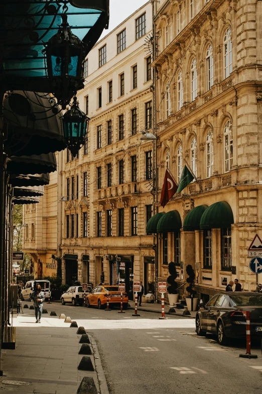 a busy street next to tall buildings with people walking around