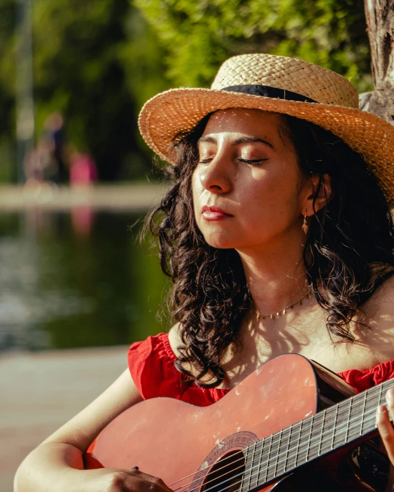 a beautiful woman in red holding a guitar