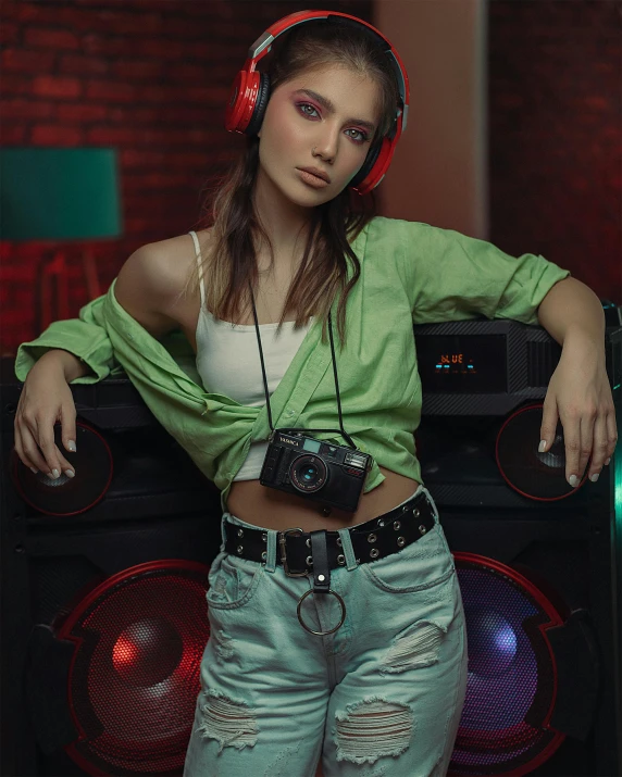 a woman is posing with headphones and music equipment