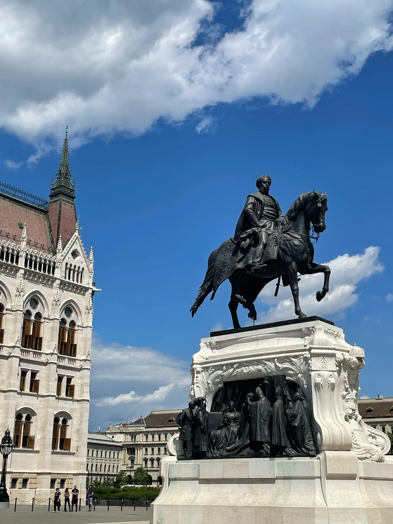 a statue is in front of a castle