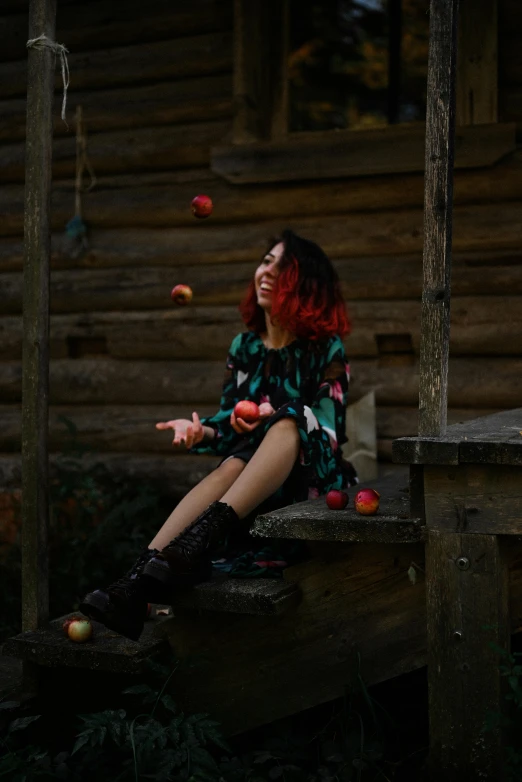 the woman is sitting on a bench eating apples