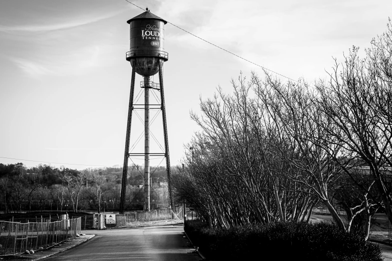 an old water tower in the middle of some trees