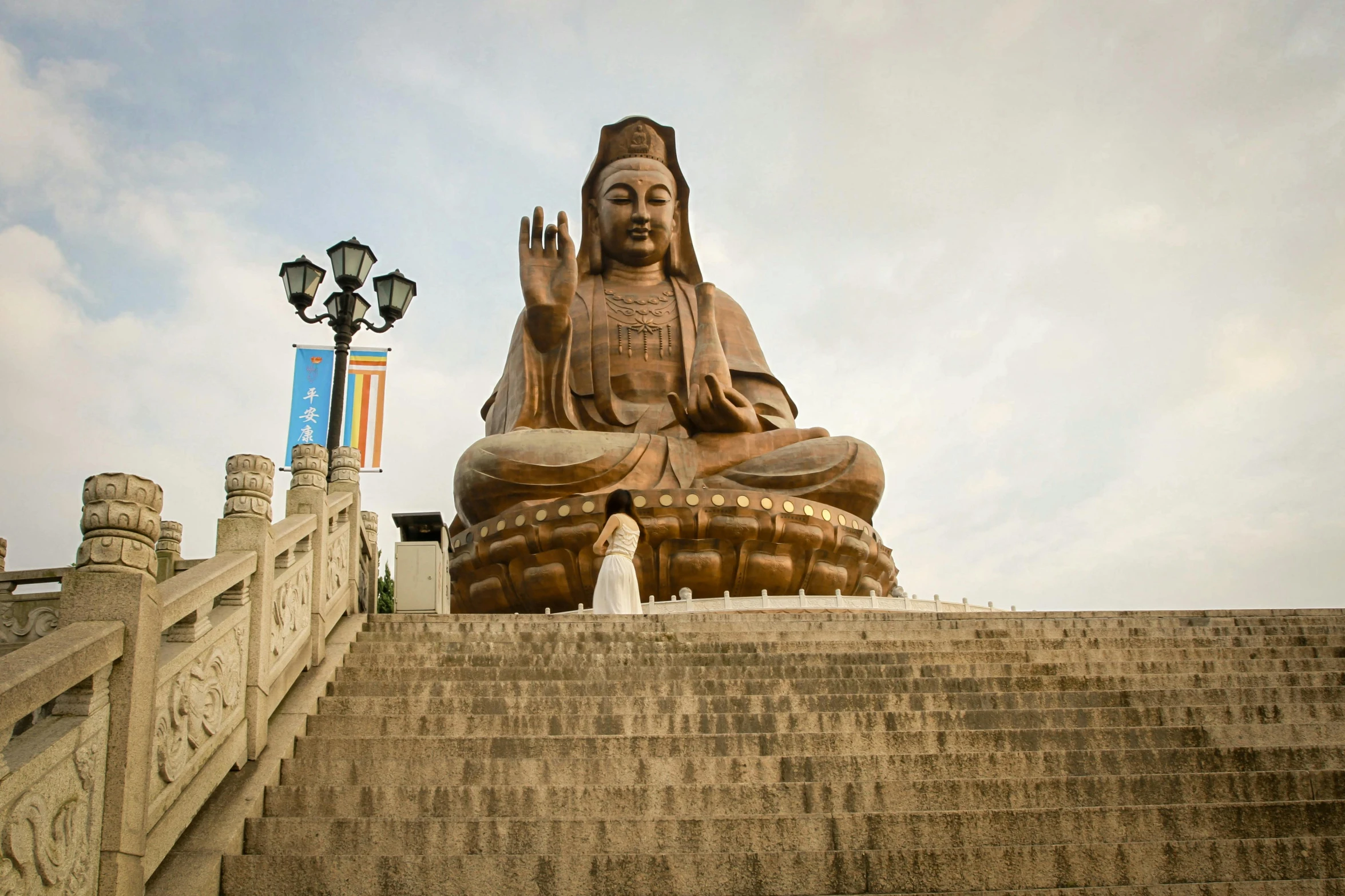 a big statue on some steps in front of some stairs