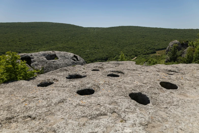 a rocky hillside with rocks and grass