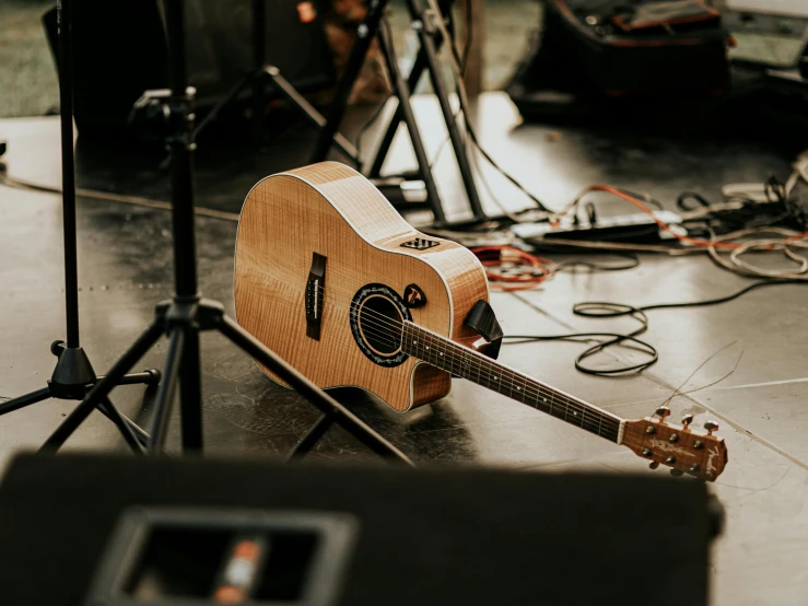 a guitar is surrounded by other musical equipment