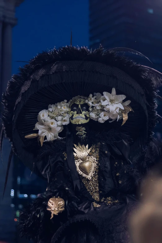 a women in a black hat with white flowers