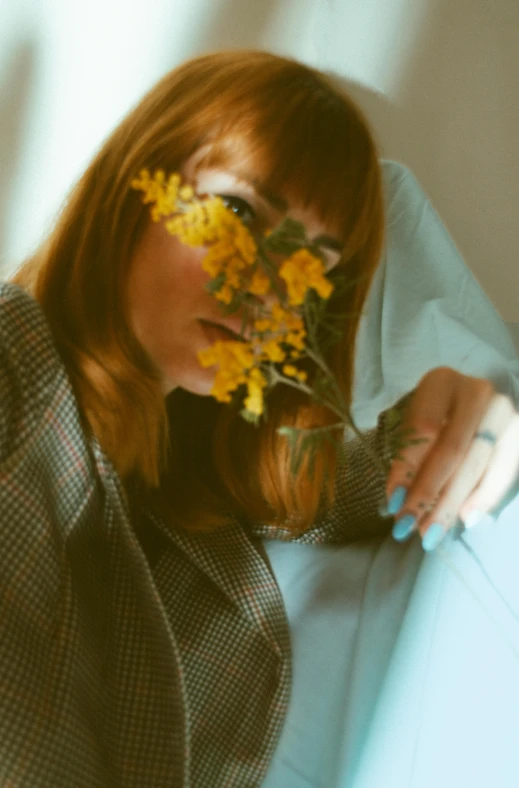 a woman sitting down with flowers on her head