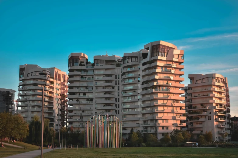 an array of high rise buildings in a grassy field