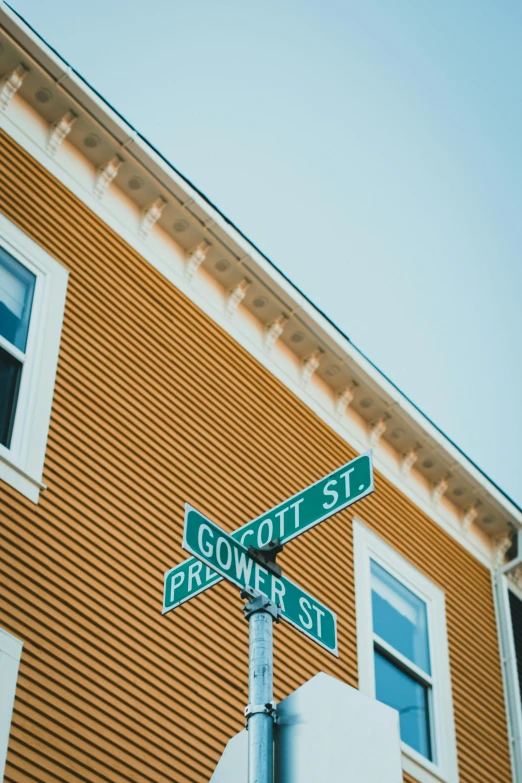 a stop sign on the corner of scott st and flower street