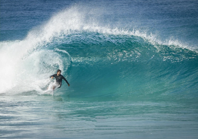 a person surfing a wave while it is about to come crash