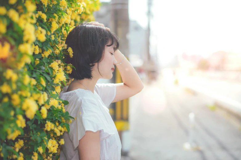 a woman wearing short hair with an expression on her face looking out into the distance