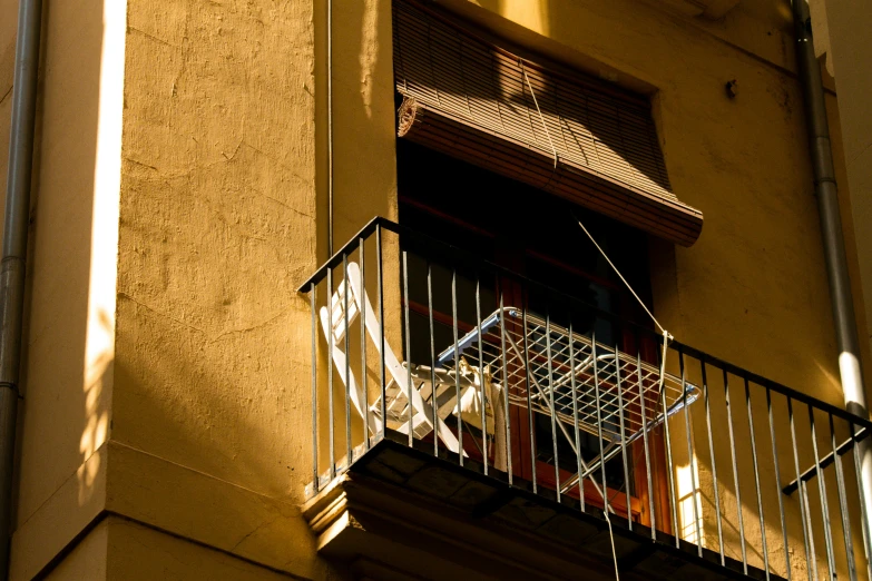 a bicycle with a basket attached to it, in a balcony area