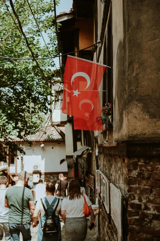 a group of people walking down a city street