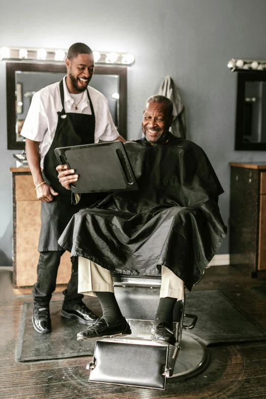 a man standing next to a man  his hair