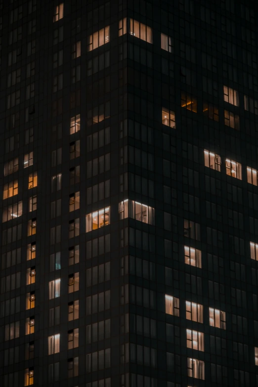 windows lit up on the side of an office building