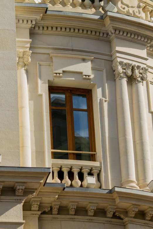 a balcony overlooking an ornate building with a clock in the middle of it