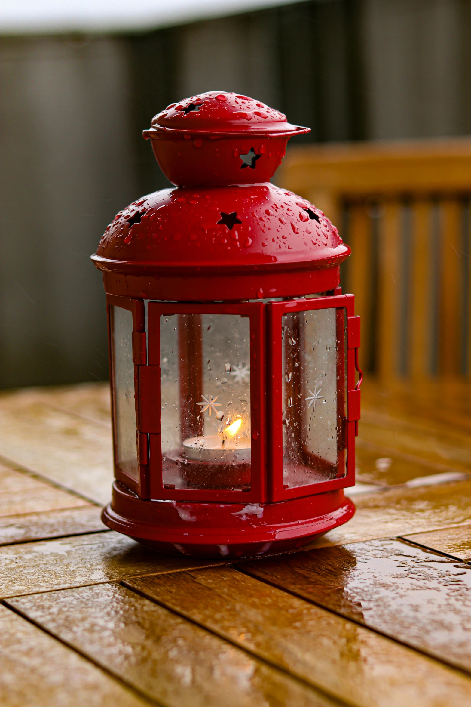 the red lantern is on a wooden surface outside