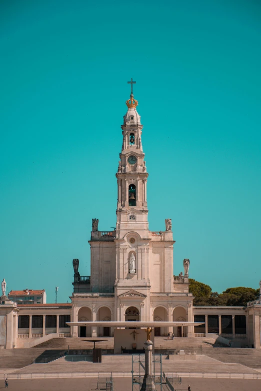 a large white building with a tower with a clock