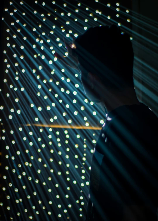 a man standing in front of some bright lights