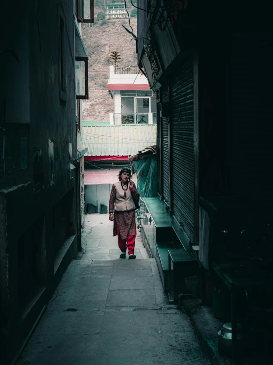 a person is walking down the narrow alley way