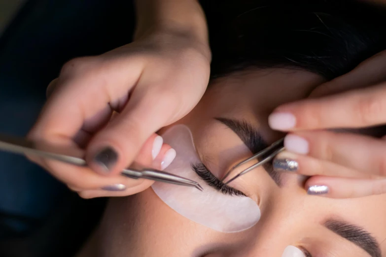 the woman is getting her eyebrows decorated