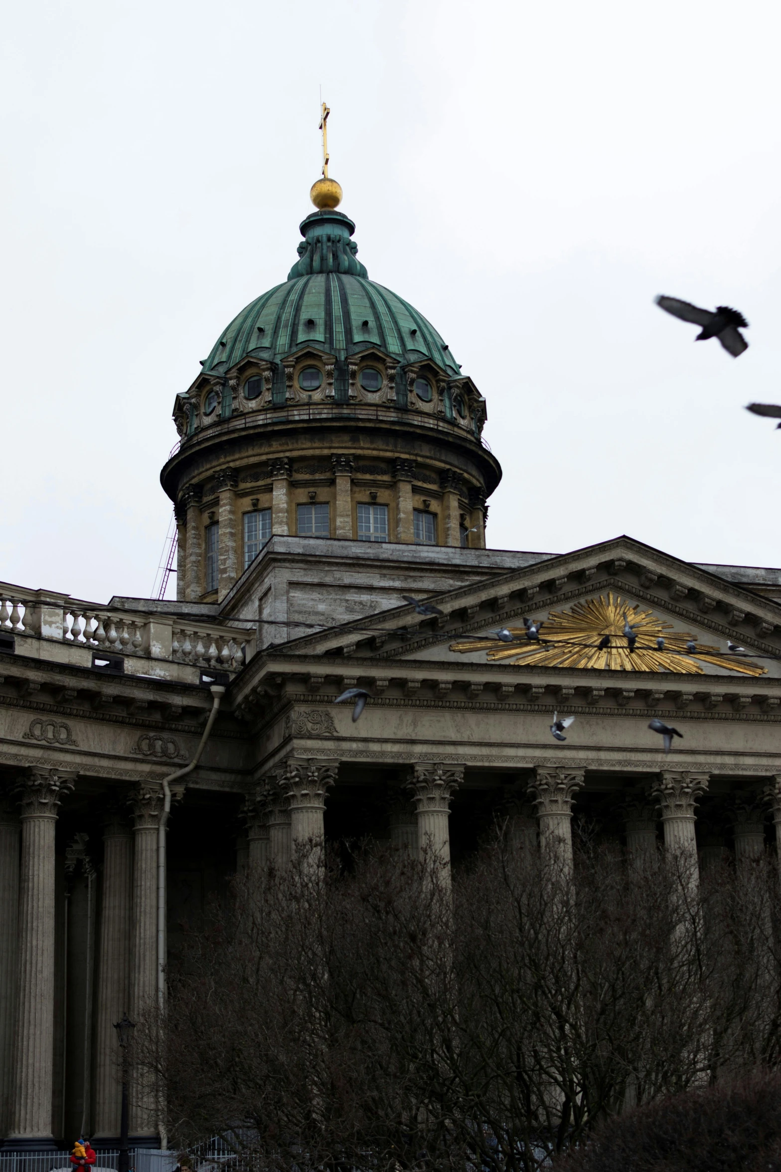 two birds flying over the roof of an old building