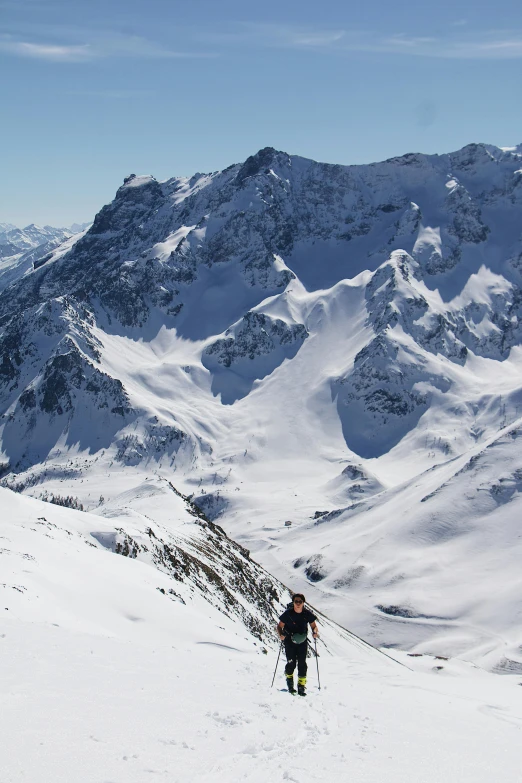 a man is trekking up a mountain ridge