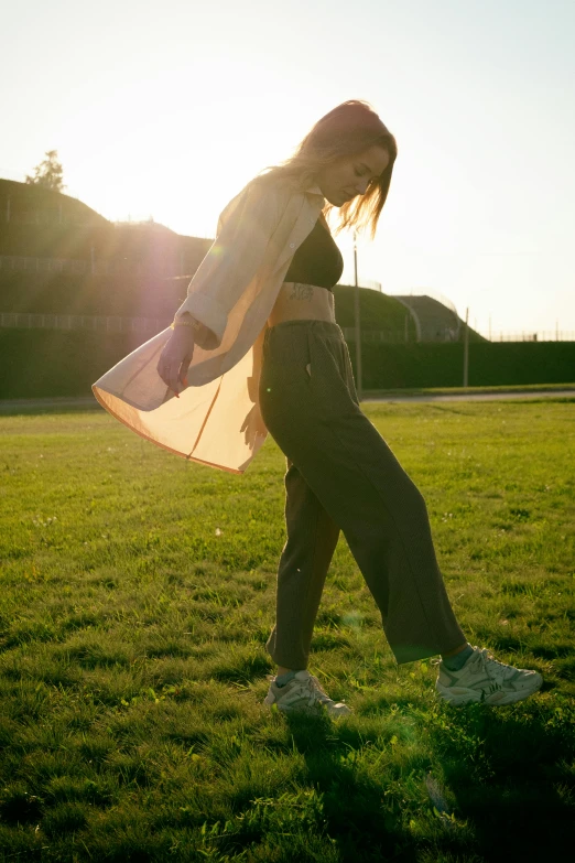 a person standing in the grass with their surfboard