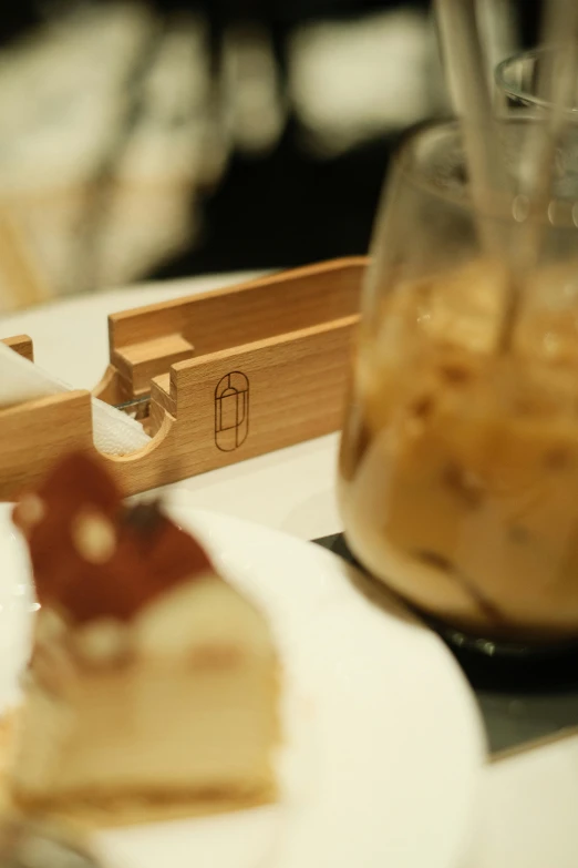 table with a small pastry in a glass on it