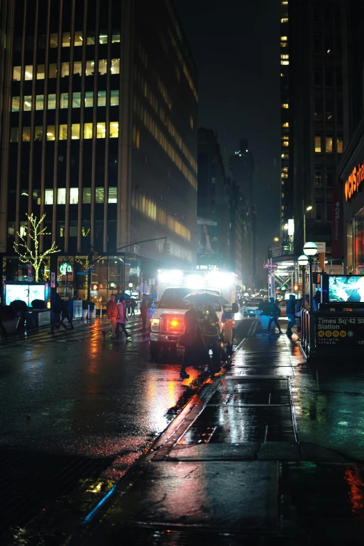 people walking in the rain on a city street