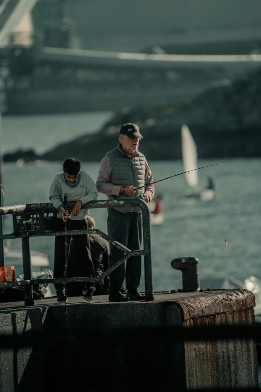 two men fishing from the back of a boat