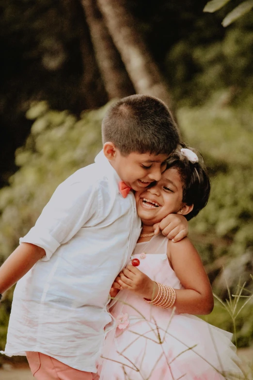 two children play with each other as they smile