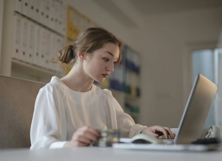 a person using a laptop at a table