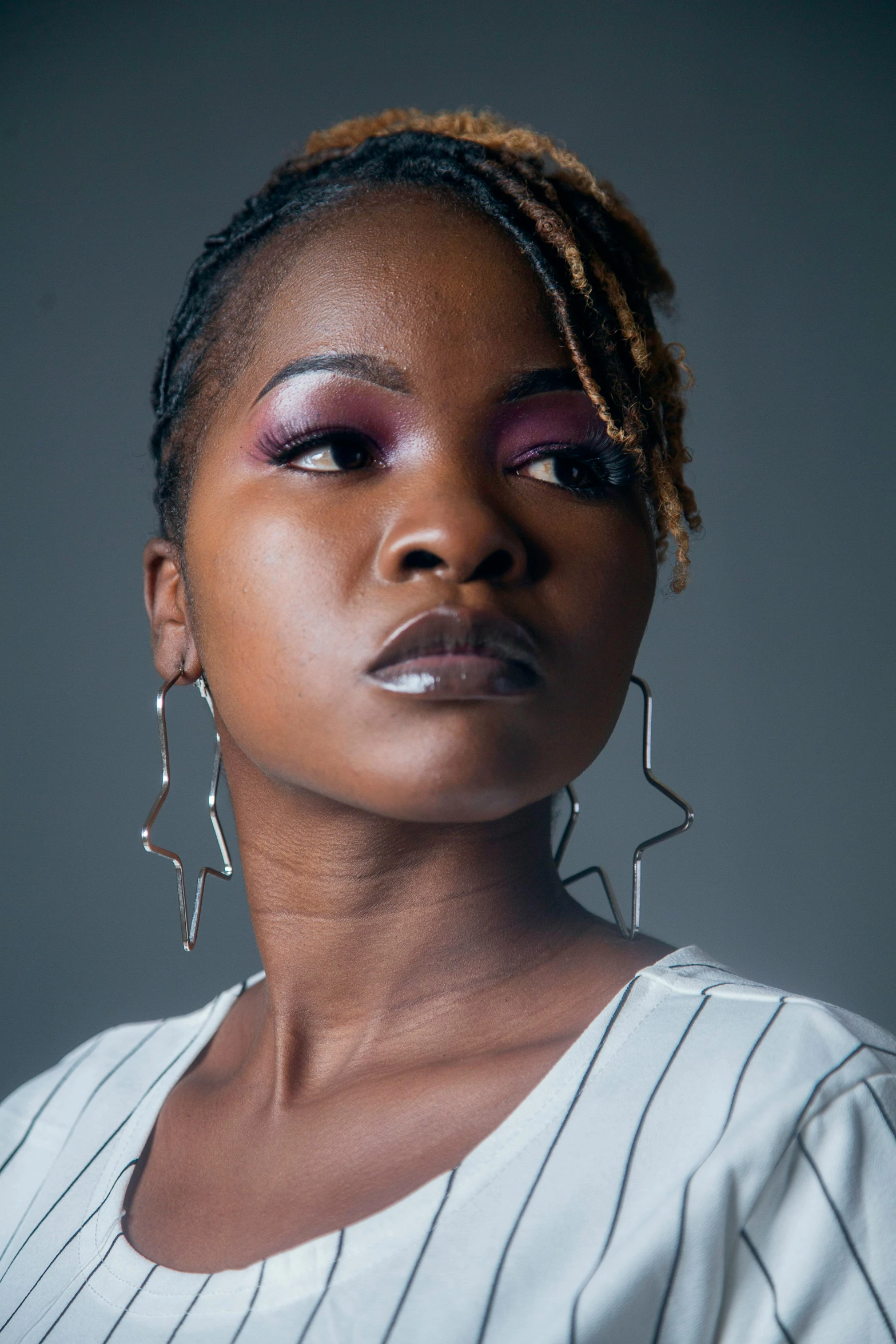 a close up po of a woman with purple makeup